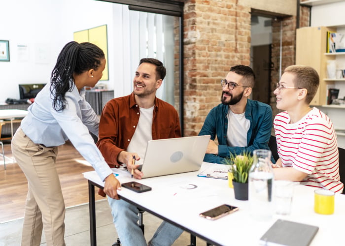 Cheerful coworkers having a productive business discussion in a modern office.