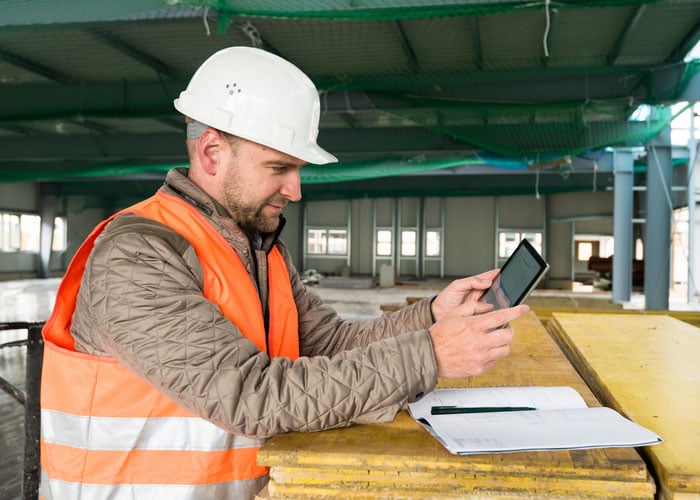 construction supervisor with digital tablet on site