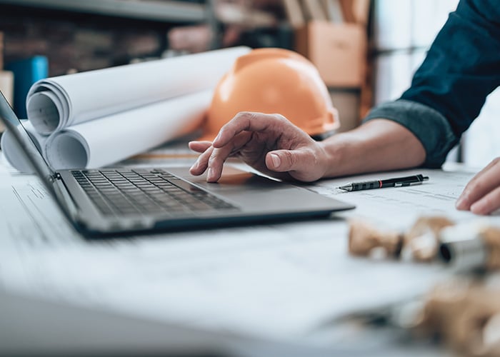 Construction worker architect on a laptop