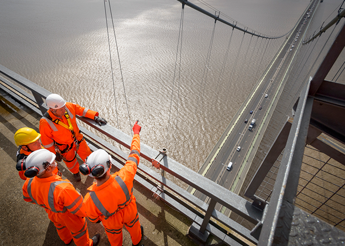 Construction workers on a bridge