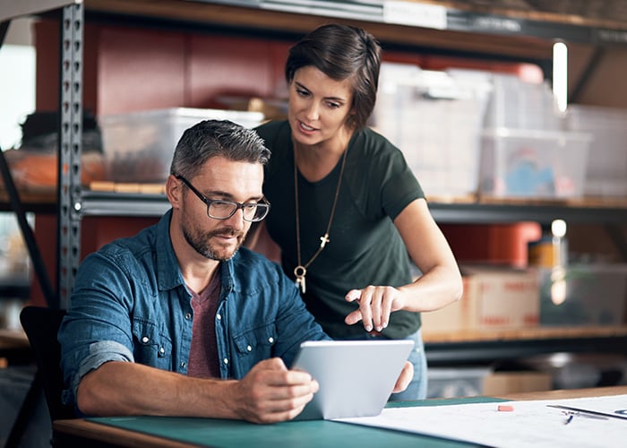 Coworkers looking at an tablet device