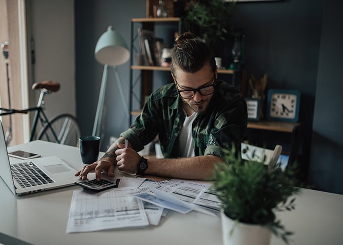 Man crunching numbers with calculator
