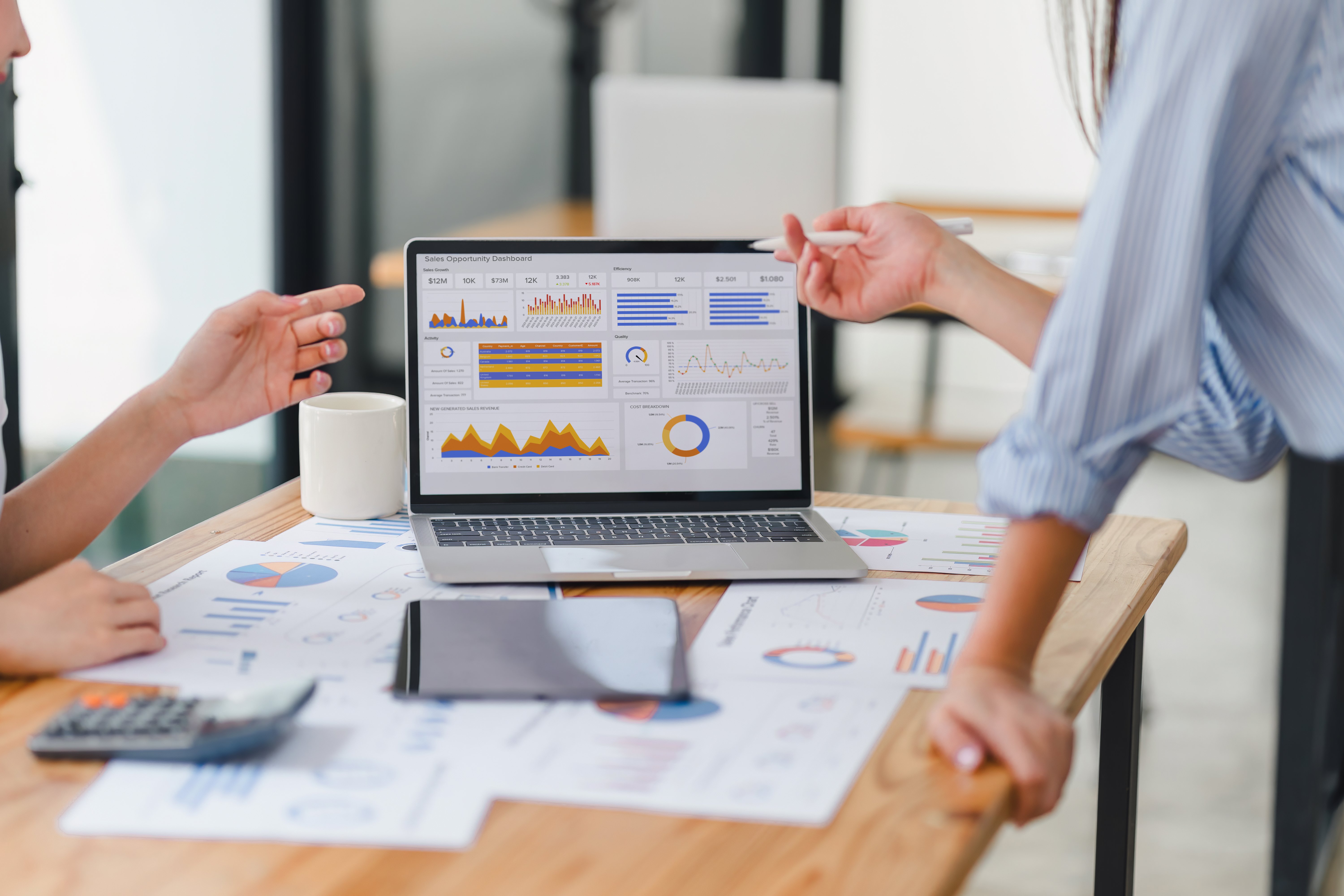 Business people looking at sales opportunity dashboard