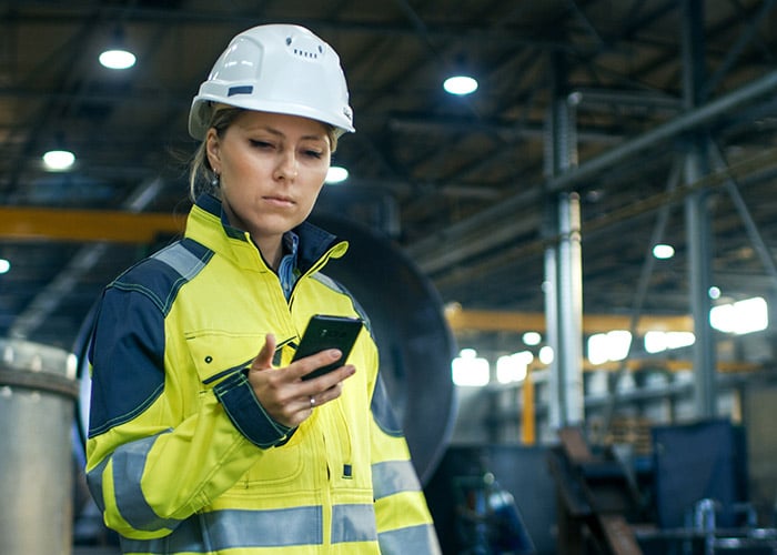 Female Industrial Worker Using a Mobile Phone