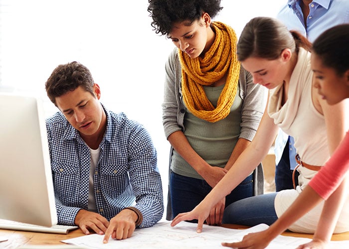 Group of young businesspeople discussing plans for their business