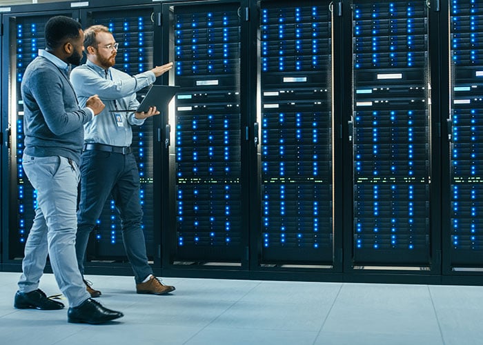 IT Technicians Inspecting and Managing Server Infrastructure in Data Center