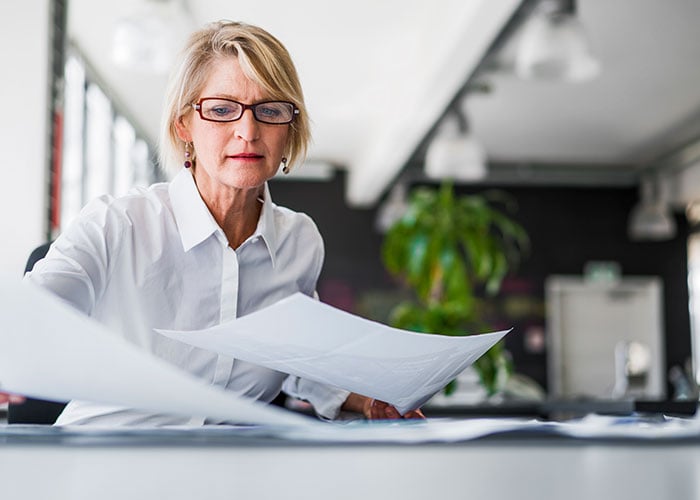 Person reviewing documents at a desk