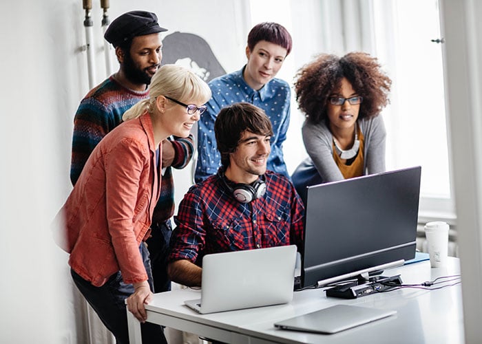 Business people discussing a project while looking at a computer monitor