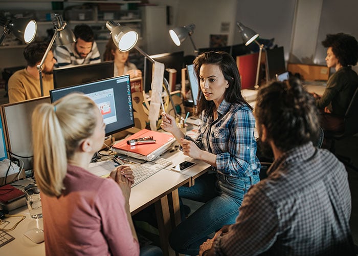 Team of young developers talking in the office