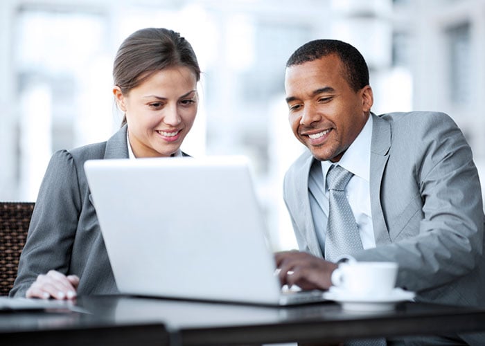 Two colleagues working on a laptop