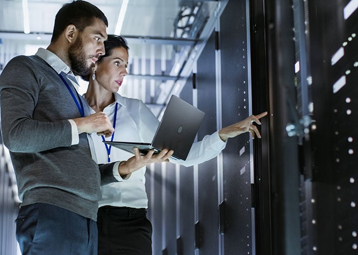 Two Server technicians standing in data center 