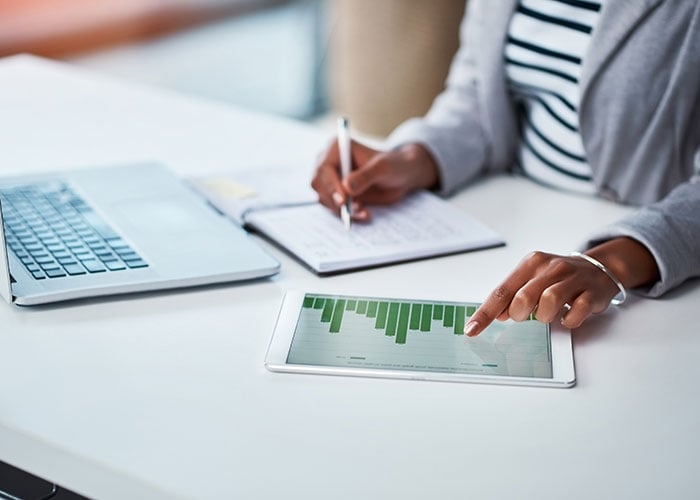 Businesswoman looking at graphs and charts on a digital tablet