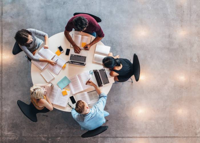 Business people working at a table together