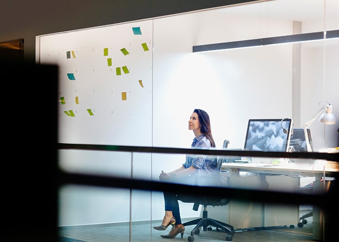 woman viewing ideas on notes in design studio